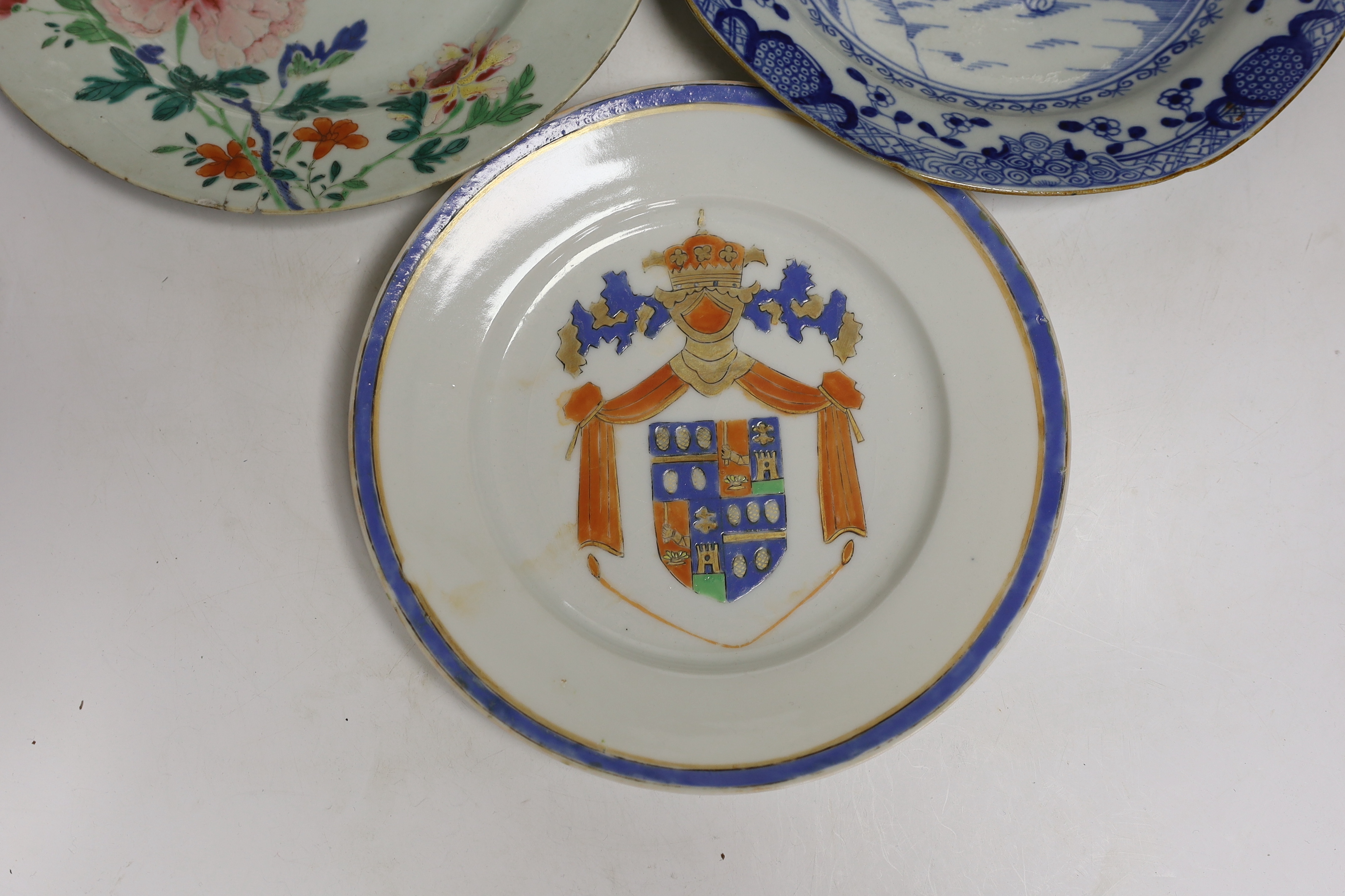 Four 18th century Chinese porcelain plates, and a later armorial plate, 21.5cm